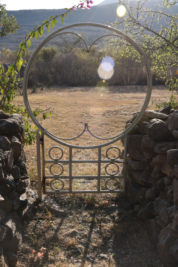 The gate is on the front wall of the property, looking westward to the mountain behind which the sun sets each evening.